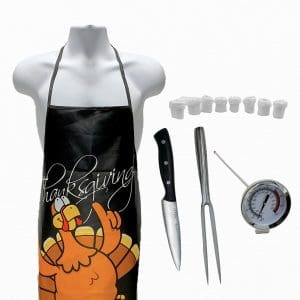 Lot #397: Thanksgiving Pilgrim Newlon Patrick Dempsey Production Used Thanksgiving Apron, Meat Thermometer, Carving Fork, Carving Knife & Turkey Leg Covers